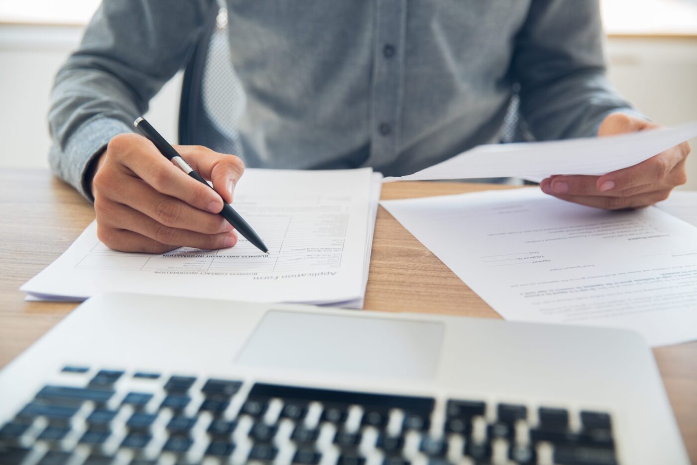 Reviewing and signing documents at a desk